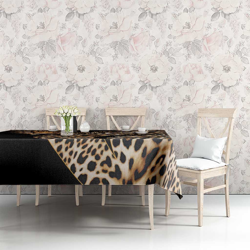 African leopard skin pattern tablecloth on table with floral design backdrop, black and tan.