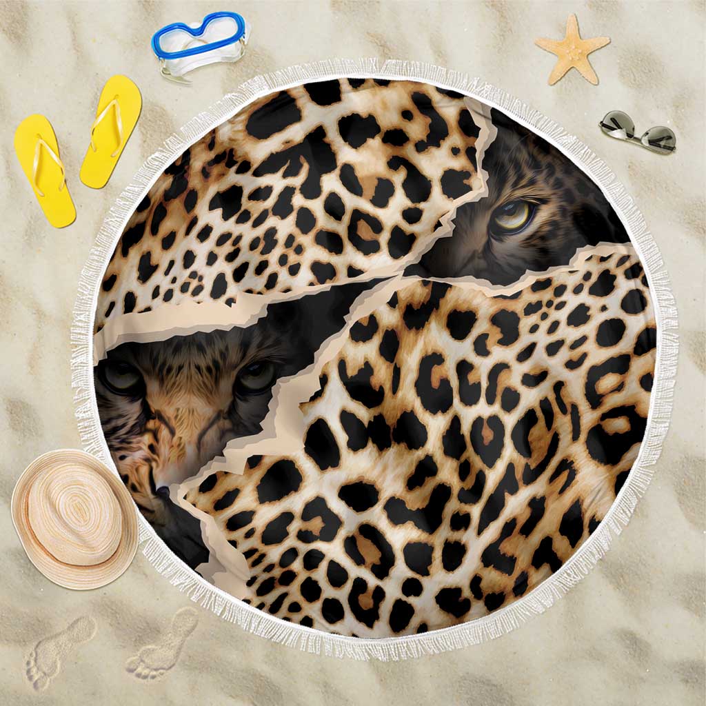 Round leopard-print beach blanket with black, tan, and cream spots; white fringed edge