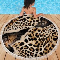 Round leopard-print beach blanket with white fringed edge, draped over a person’s back
