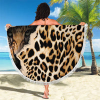 Round leopard-print beach blanket with white fringed edge, held up for full pattern view