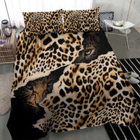 Black leopard-print bedding set with cat faces and bold animal spots on duvet and pillows