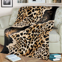 Black and tan leopard-print blanket with animal-face graphic, draped on an armchair