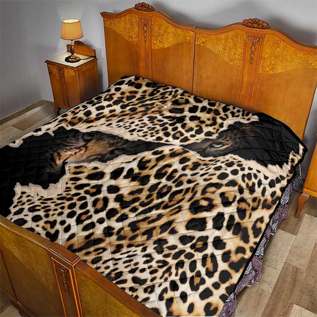 African leopard-skin pattern quilt on a bed with black backing and cream-brown leopard pattern