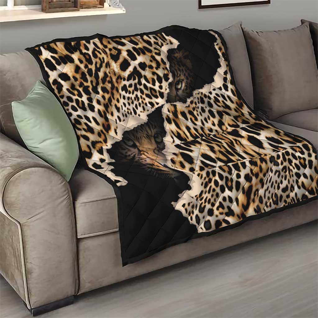African leopard-skin pattern quilt draped on a sofa with black quilted sections and spots
