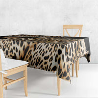 Leopard-print tablecloth draped over dining table edge, black and tan spots