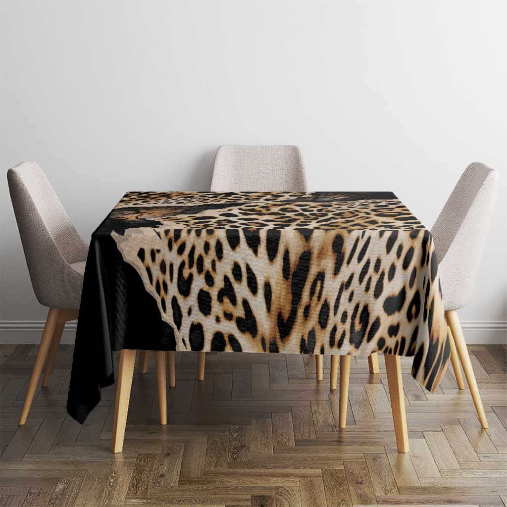 Leopard-print tablecloth with dark border covering dining table, black and tan