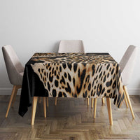 Leopard-print tablecloth with dark border covering dining table, black and tan