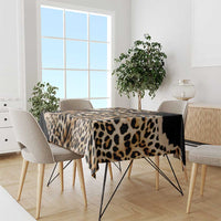 Leopard-print tablecloth with tan spots and black band across table