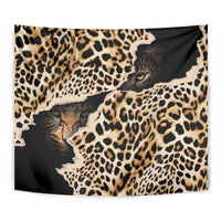 Leopard skin tapestry in black and tan with close-up cat faces and spots