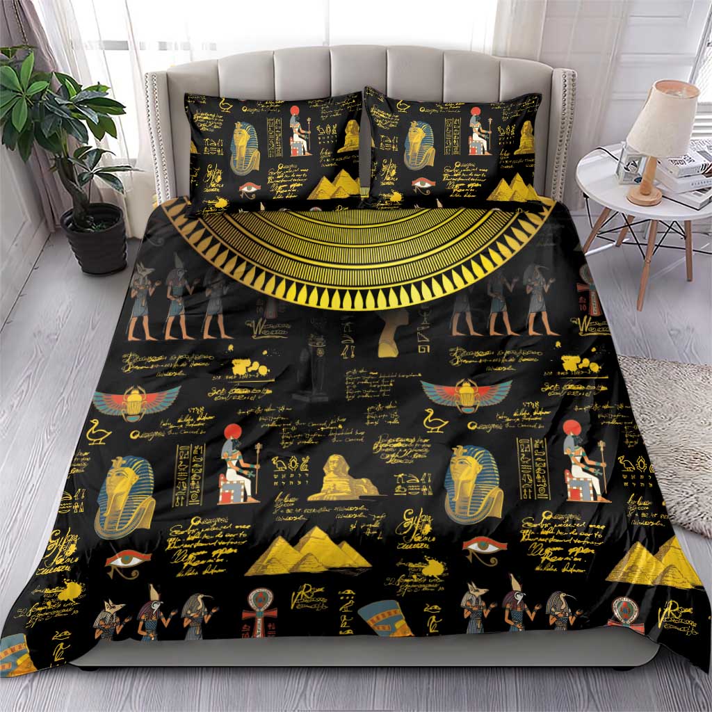 Black bedding set with gold Egyptian hieroglyph and pharaoh prints, spread on bed with pillows