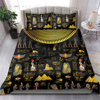 Black bedding set with gold Egyptian hieroglyph and pharaoh prints, spread on bed with pillows