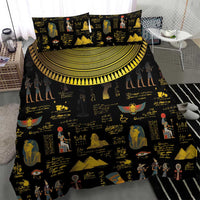 Black bedding set with gold Egyptian hieroglyph and pharaoh prints, duvet centered with pillow