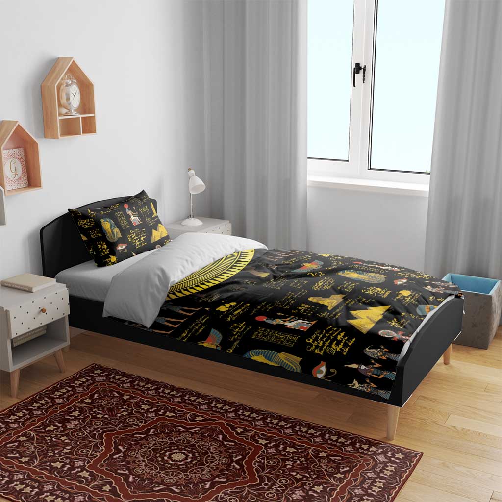 Black bedding set with gold Egyptian hieroglyph and pharaoh prints on bed with two pillows