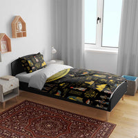 Black bedding set with gold Egyptian hieroglyph and pharaoh prints on bed with two pillows
