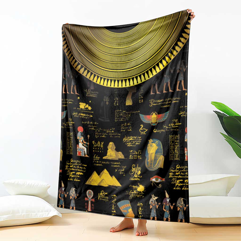 Black Egyptian blanket showing large gold semicircle trim and hieroglyph pattern