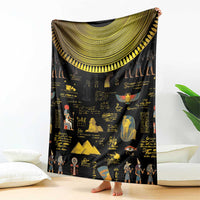 Black Egyptian blanket showing large gold semicircle trim and hieroglyph pattern