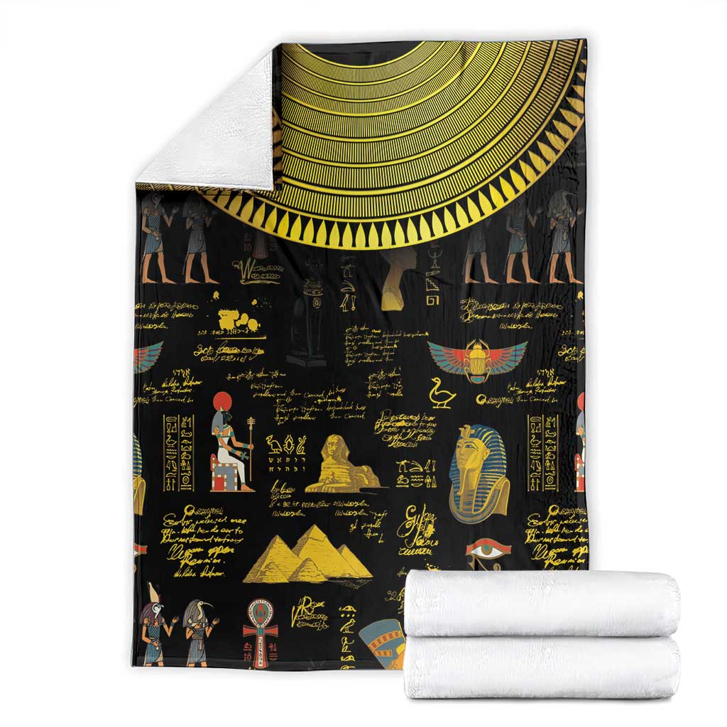 Black Egyptian hieroglyphs blanket with gold semicircle collar, folded with white linens