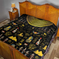 Black Egyptian hieroglyph quilt spread on bed, gold arch border with figure prints