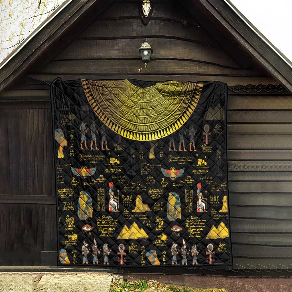 Black quilt hanging indoors with gold crescent arch and colorful Egyptian motifs