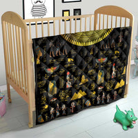 Black Egyptian hieroglyph quilt over crib, gold crescent arch and colorful figure prints