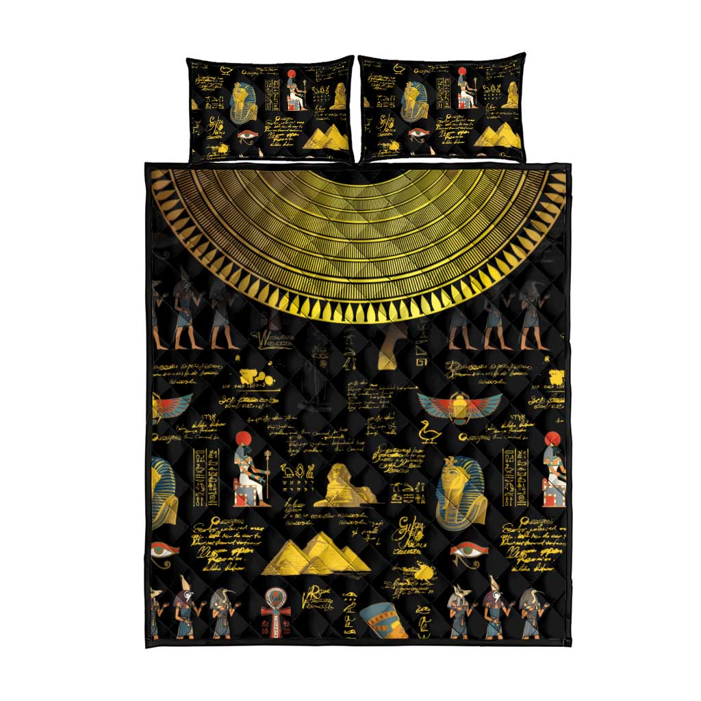 Black quilt bed set with gold sun-semicircle motif, hieroglyphs, and two pillow shams