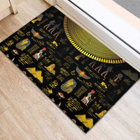 Black rubber doormat with Egyptian figures and hieroglyphs, featuring a golden sun-disk stripe