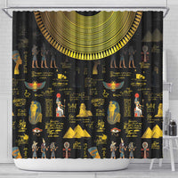 Black shower curtain with gold Egyptian symbols, figures, and hieroglyph-style text pattern.