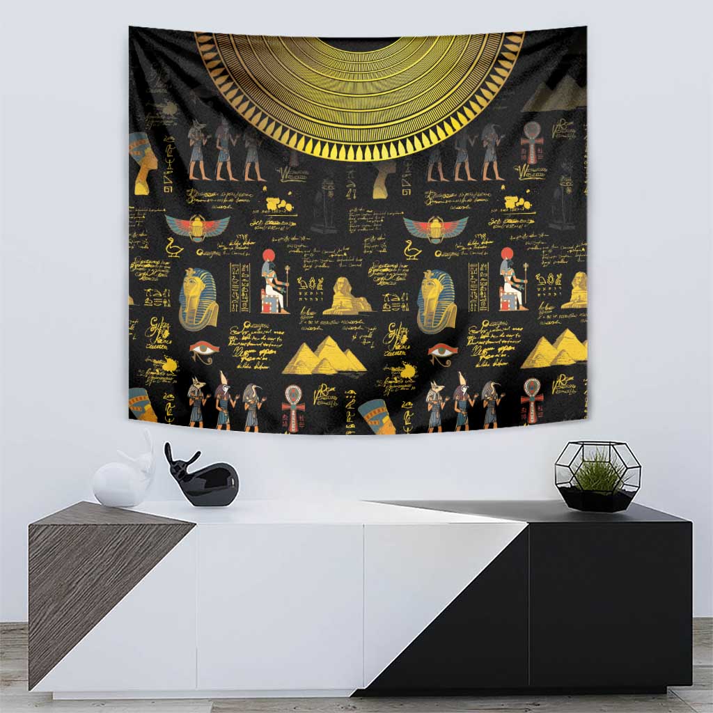 Black tapestry featuring gold Egyptian scenes, hieroglyph-style writing, and crescent arc border