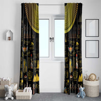 Black Egyptian window curtains with gold hieroglyph and statue motifs, gathered at top.