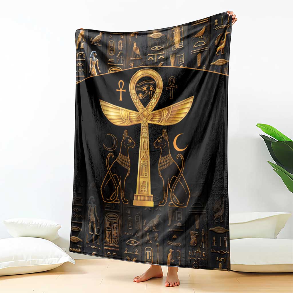 Black throw blanket with gold Ankh and Eye of Horus symbols, draped on floor