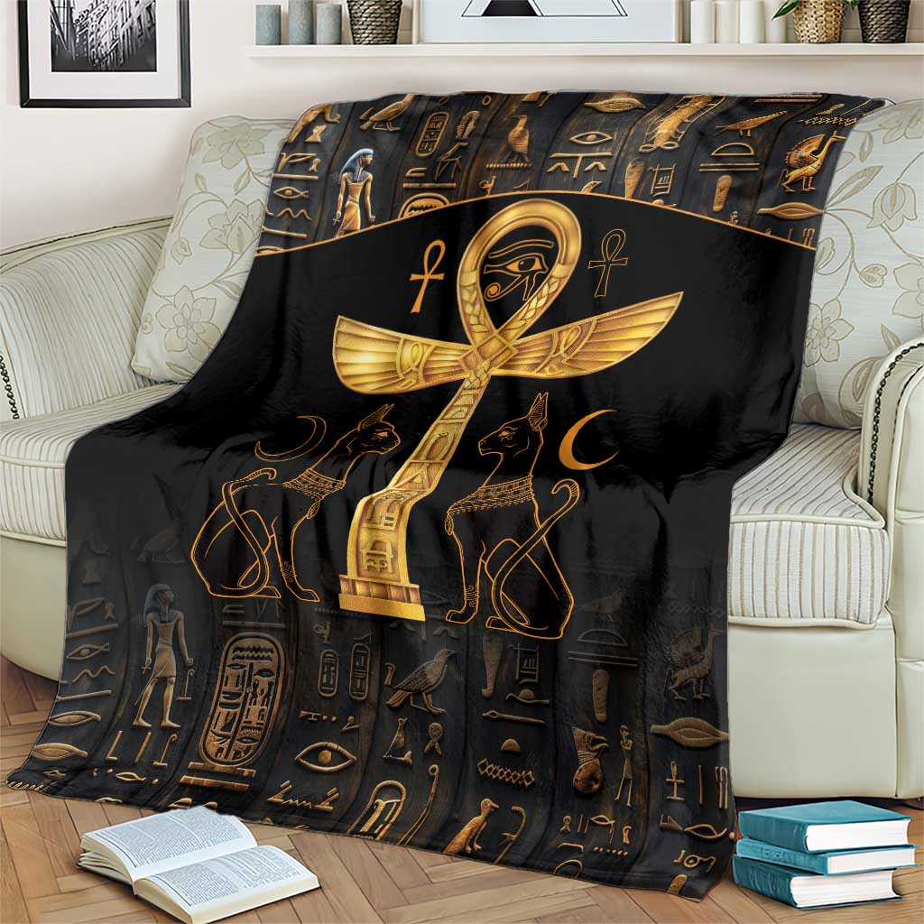 Black throw blanket with gold Ankh cross and Eye of Horus, centered on couch