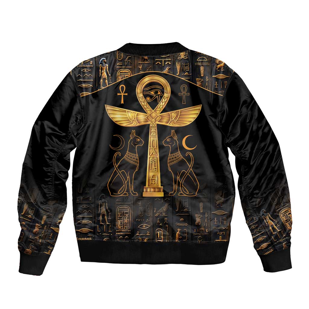 Black bomber jacket with gold Egyptian symbol pattern and central winged Eye of Horus