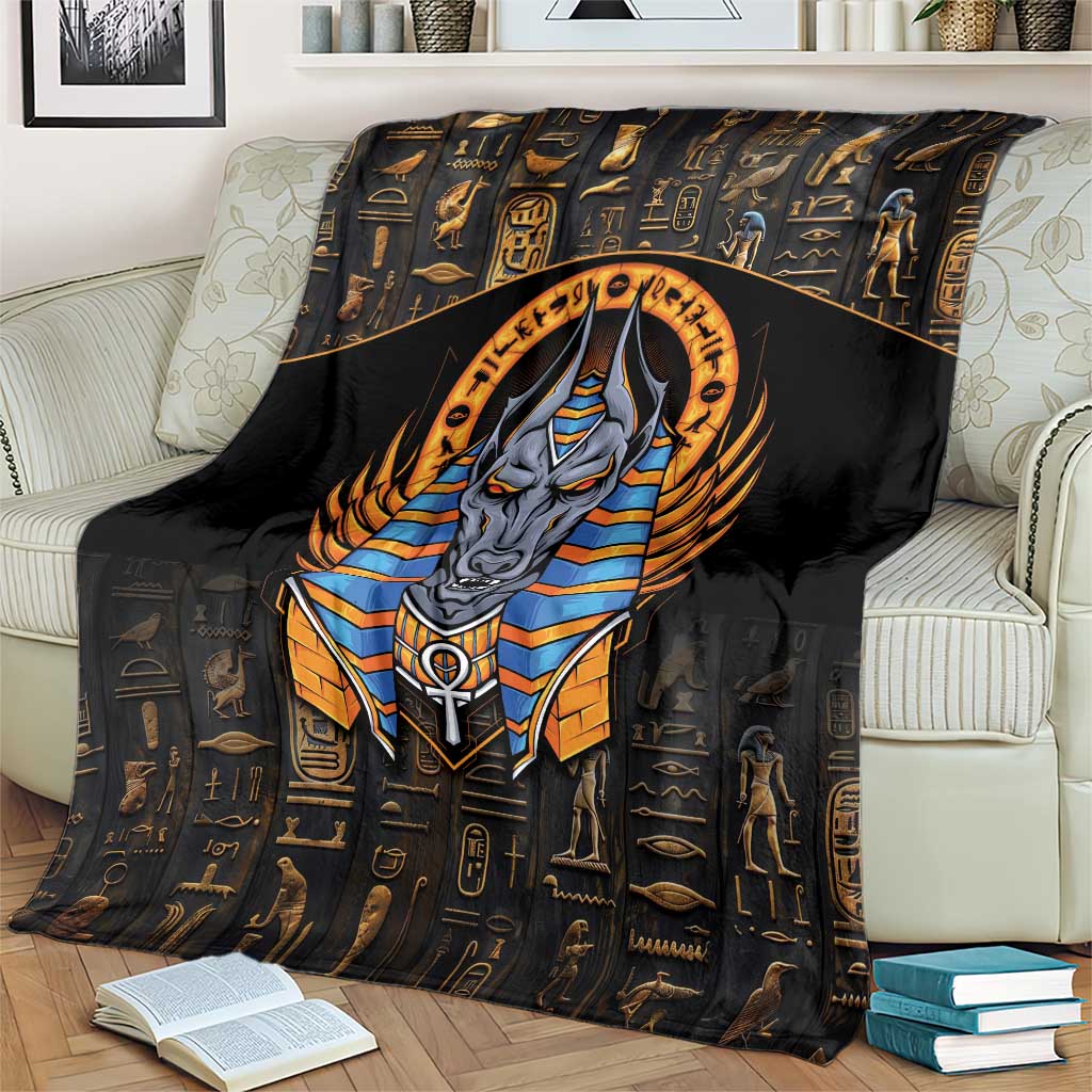 Black Anubis throw blanket with large golden halo and blue-striped armor design