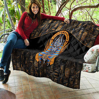 Black throw quilt with gold hieroglyphs, central Anubis portrait, and padded diamond look