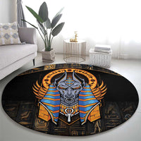 Black round area rug featuring Anubis in blue and gold with winged headdress