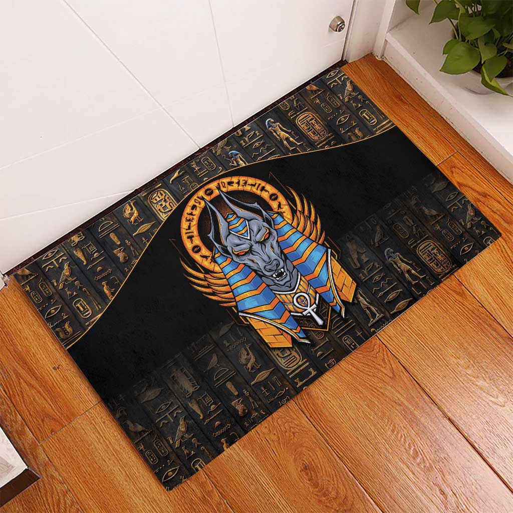 Corner view black Egyptian Anubis rubber doormat with gold and blue Anubis artwork