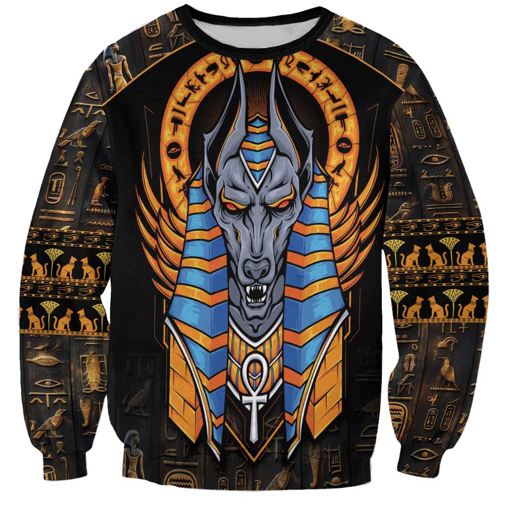 Black unisex sweatshirt with large Anubis face graphic and gold hieroglyph patterns