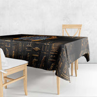 Black Egyptian hieroglyph tablecloth draped over table edge