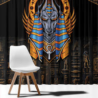 Black curtain panel close-up with detailed Anubis face emblem in blue and gold