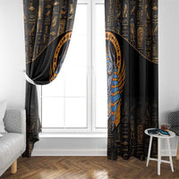 Black curtain panel with gold hieroglyphs and Anubis graphic framing a window