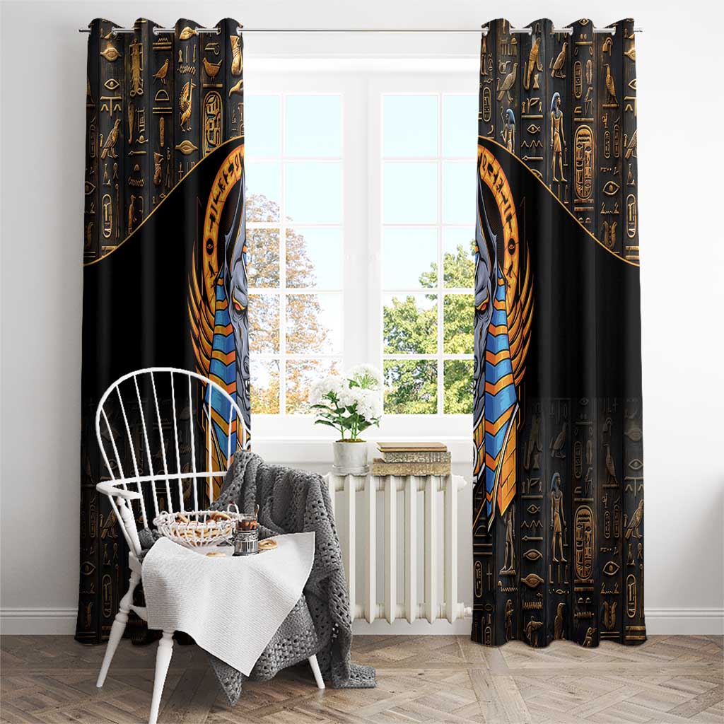 Black curtain panels with gold symbols and tall Anubis face in blue-gold