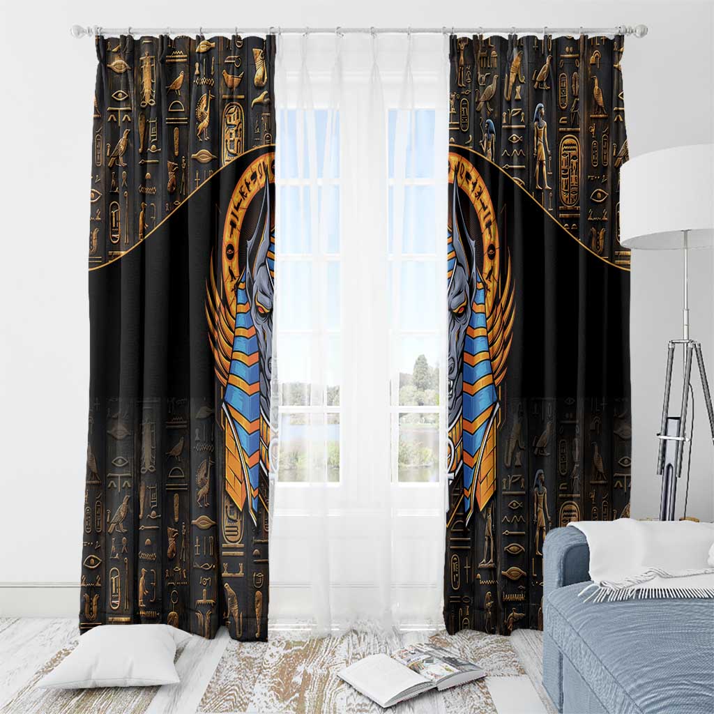 Black window curtain panels with gold hieroglyphs and centered Anubis emblem