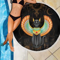 Black round beach blanket with winged Egypt cat center, fringed white edge by pool