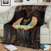 Black Egyptian cat wing blanket on a beige couch, close view of winged cat emblem