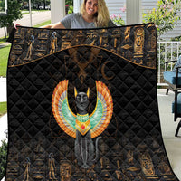 Black quilt blanket with Egyptian cat and wing emblem, surrounded by gold hieroglyph patterns