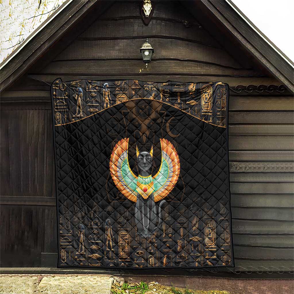Black wall-hanging quilt with Egyptian cat wings emblem and gold patterned borders