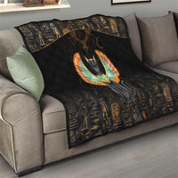 Black quilt blanket draped on a sofa, with centered Egyptian cat wings emblem