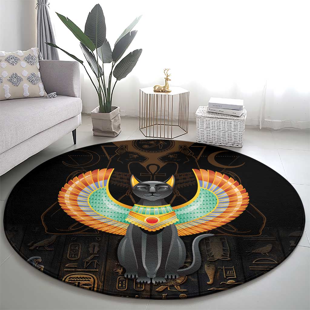 Black round area rug with central winged Egypt cat graphic, colorful headdress and symbols