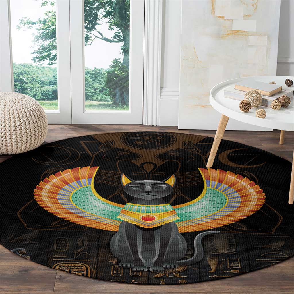 Black round area rug with winged Egypt cat design and hieroglyph symbols across border