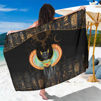 Black sarong with winged cat graphic and gold hieroglyph pattern, shown draped
